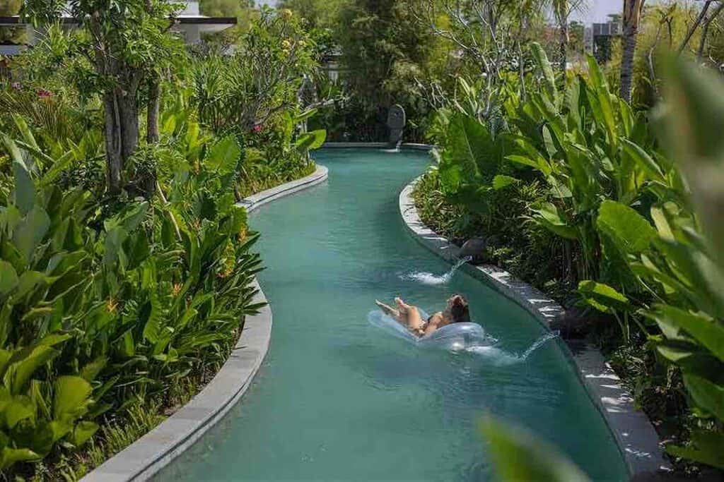 Bali stone pool tiles in a lush tropical resort setting.